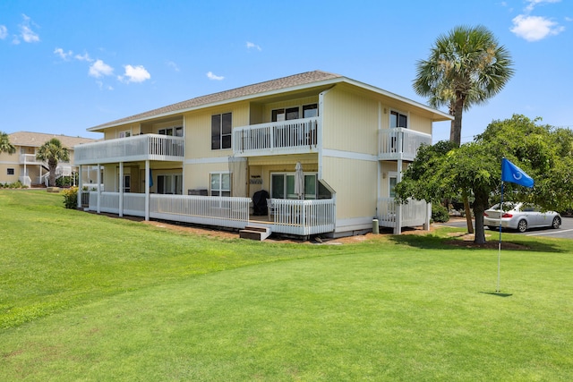 rear view of property with a lawn