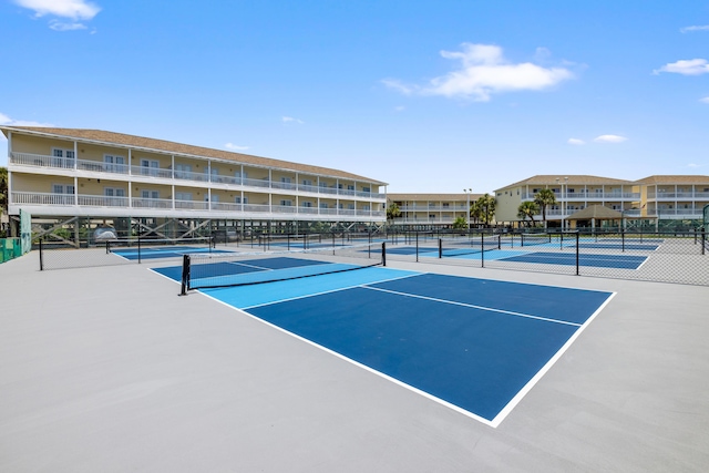 view of tennis court featuring fence