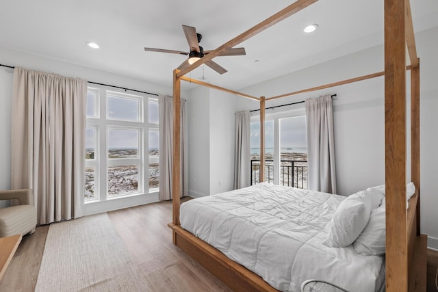 34 Gulf Breeze Ct, Destin, FL 32541 - bedroom with recessed lighting, a water view, and access to exterior
