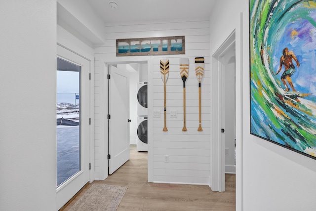 34 Gulf Breeze Ct, Destin, FL 32541 - hallway with light wood finished floors and stacked washer and clothes dryer