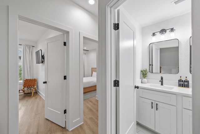 34 Gulf Breeze Ct, Destin, FL 32541 - ensuite bathroom featuring vanity, baseboards, ensuite bathroom, and wood finished floors
