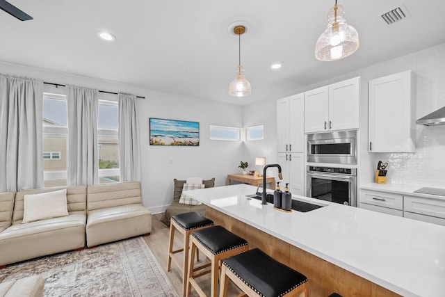 34 Gulf Breeze Ct, Destin, FL 32541 - kitchen featuring white cabinets, a sink, visible vents, and hanging light fixtures