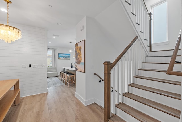 34 Gulf Breeze Ct, Destin, FL 32541 - stairway with recessed lighting, a chandelier, wood finished floors, wooden walls, and baseboards