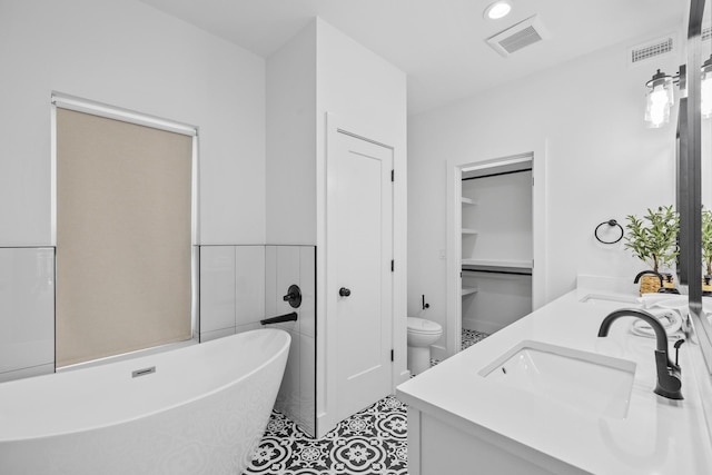 34 Gulf Breeze Ct, Destin, FL 32541 - bathroom featuring a freestanding bath, double vanity, a sink, and visible vents