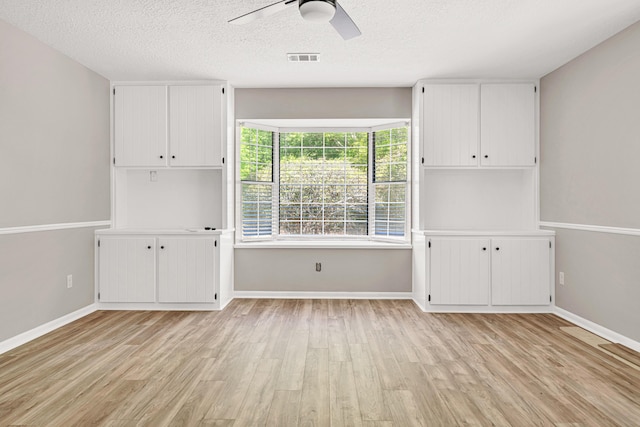 5700 Country Squire Dr, Milton, FL 32570 - unfurnished room with light wood-type flooring, ceiling fan, baseboards, and a textured ceiling