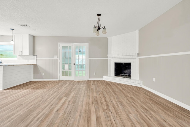 5700 Country Squire Dr, Milton, FL 32570 - unfurnished living room with light wood-style floors, plenty of natural light, visible vents, and wainscoting