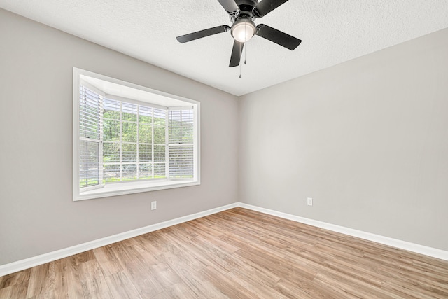 5700 Country Squire Dr, Milton, FL 32570 - empty room with light wood finished floors, baseboards, a textured ceiling, and ceiling fan