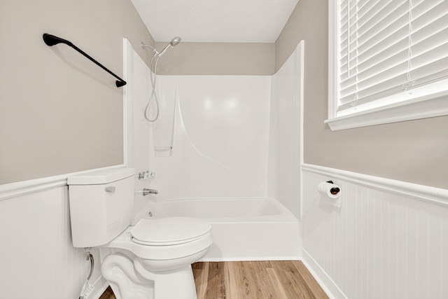 5700 Country Squire Dr, Milton, FL 32570 - full bathroom with toilet, wood finished floors, bathtub / shower combination, and a wainscoted wall