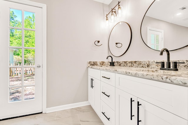 5700 Country Squire Dr, Milton, FL 32570 - bathroom featuring visible vents, marble finish floor, a sink, double vanity, and baseboards