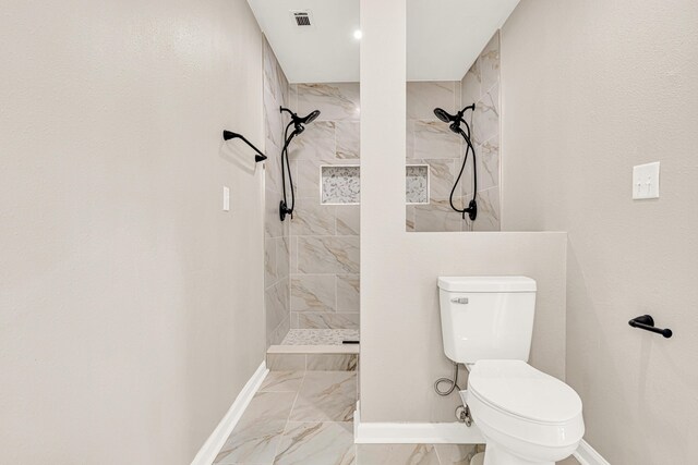5700 Country Squire Dr, Milton, FL 32570 - full bathroom featuring visible vents, baseboards, toilet, tiled shower, and marble finish floor