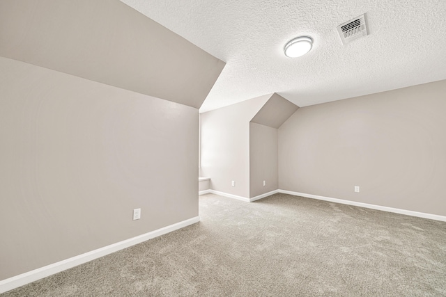 5700 Country Squire Dr, Milton, FL 32570 - additional living space with a textured ceiling, visible vents, carpet flooring, lofted ceiling, and baseboards