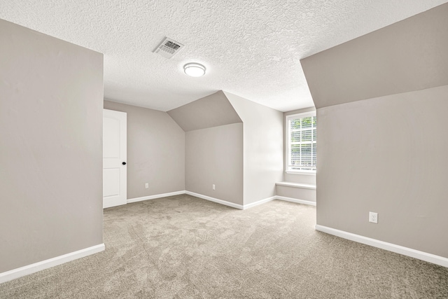 5700 Country Squire Dr, Milton, FL 32570 - additional living space with baseboards, vaulted ceiling, a textured ceiling, visible vents, and carpet
