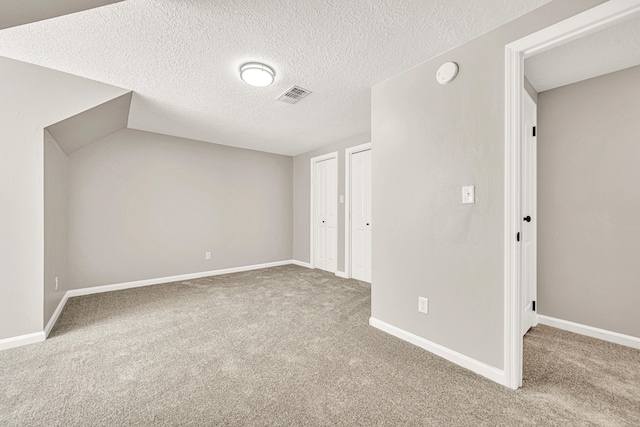 5700 Country Squire Dr, Milton, FL 32570 - unfurnished bedroom featuring carpet flooring, visible vents, a textured ceiling, and multiple closets
