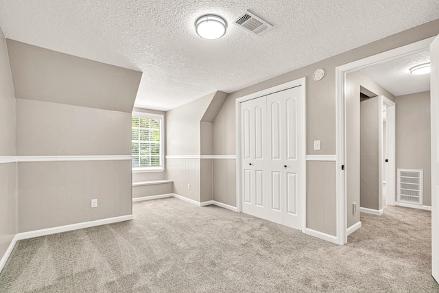 5700 Country Squire Dr, Milton, FL 32570 - bonus room featuring carpet flooring, visible vents, a textured ceiling, and baseboards