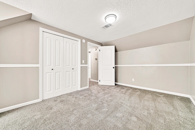 5700 Country Squire Dr, Milton, FL 32570 - bonus room featuring carpet floors, visible vents, vaulted ceiling, and a textured ceiling