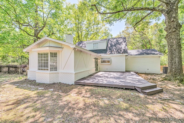 5700 Country Squire Dr, Milton, FL 32570 - back of property featuring central air condition unit, a chimney, brick siding, a deck, and a shingled roof