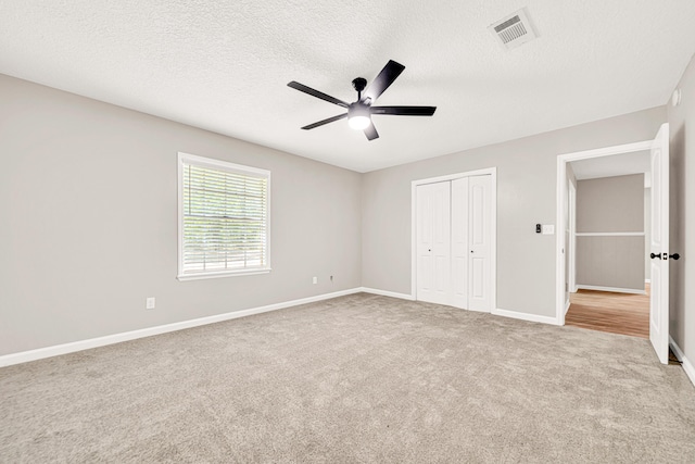 5700 Country Squire Dr, Milton, FL 32570 - unfurnished bedroom with visible vents, baseboards, a closet, a textured ceiling, and carpet flooring
