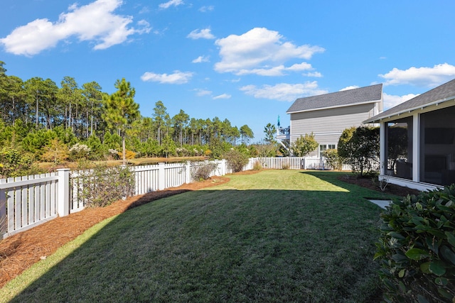141 Sandchase Cir, Watersound, FL 32461 - view of yard with a water view, a fenced backyard, and a sunroom