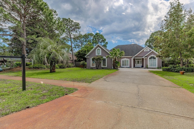 4030 Indian Trl, Destin, FL 32541 - view of front of house featuring driveway, stucco siding, and a front lawn