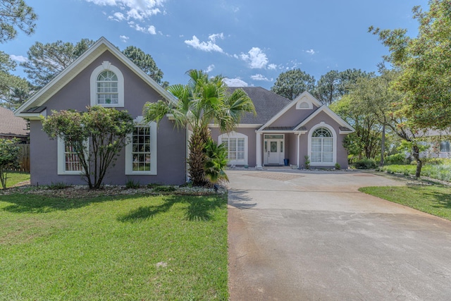 4030 Indian Trl, Destin, FL 32541 - view of front facade featuring driveway, a front yard, and stucco siding