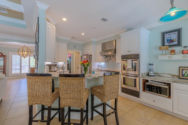 4030 Indian Trl, Destin, FL 32541 - kitchen with white cabinetry, wall chimney range hood, tasteful backsplash, and appliances with stainless steel finishes