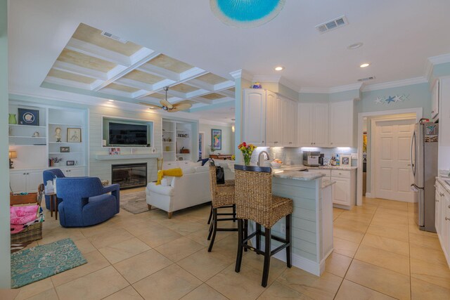 4030 Indian Trl, Destin, FL 32541 - kitchen with ornamental molding, light tile patterned floors, freestanding refrigerator, white cabinets, and visible vents