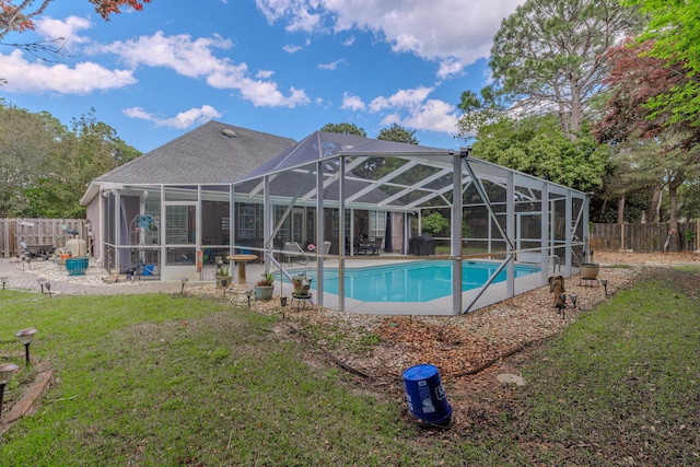 4030 Indian Trl, Destin, FL 32541 - view of swimming pool featuring a yard, a fenced backyard, a fenced in pool, and glass enclosure