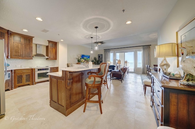 11807 Front Beach Rd Unit 2104, Panama City Beach, FL 32407 - kitchen with stovetop, wall chimney range hood, oven, and recessed lighting
