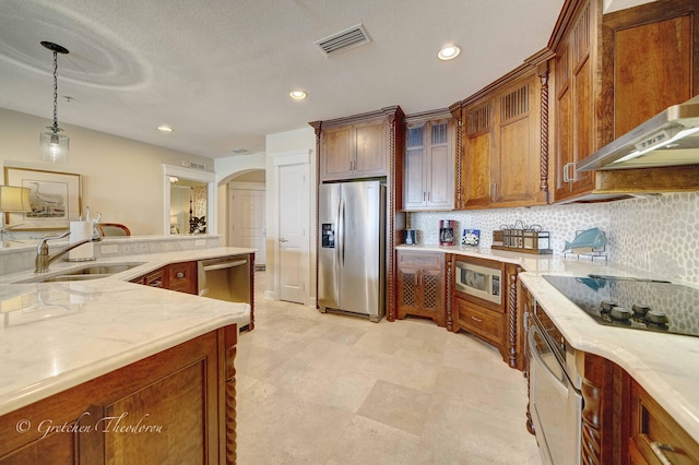 11807 Front Beach Rd Unit 2104, Panama City Beach, FL 32407 - kitchen featuring backsplash, visible vents, a sink, arched walkways, and appliances with stainless steel finishes