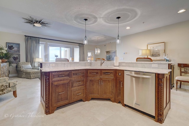 11807 Front Beach Rd Unit 2104, Panama City Beach, FL 32407 - kitchen featuring stainless steel dishwasher, a sink, open floor plan, brown cabinetry, and decorative light fixtures