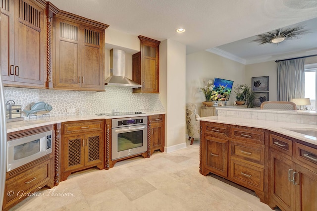 11807 Front Beach Rd Unit 2104, Panama City Beach, FL 32407 - kitchen with stainless steel appliances, ornamental molding, wall chimney exhaust hood, baseboards, and decorative backsplash