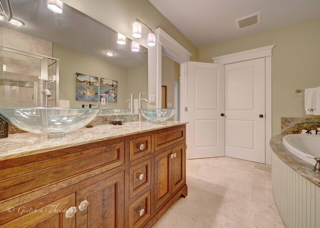 11807 Front Beach Rd Unit 2104, Panama City Beach, FL 32407 - full bath featuring visible vents, a sink, double vanity, and a stall shower
