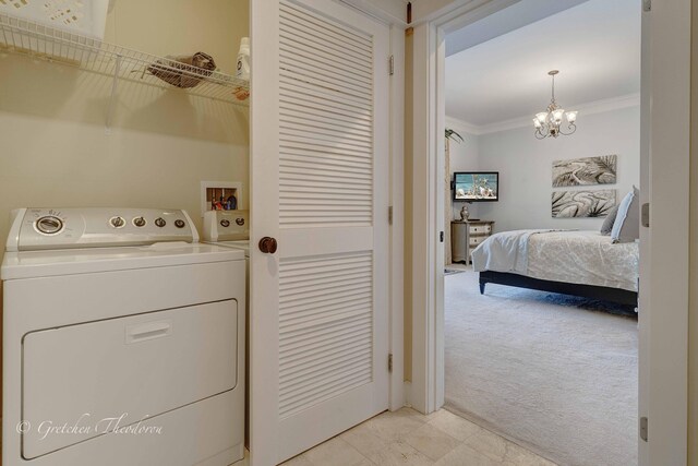 11807 Front Beach Rd Unit 2104, Panama City Beach, FL 32407 - washroom featuring laundry area, ornamental molding, washing machine and clothes dryer, a chandelier, and light colored carpet