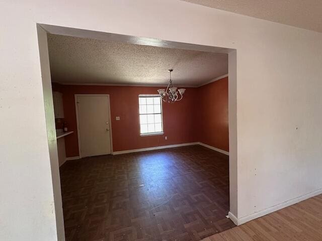 592 E Robinson Ave, Crestview, FL 32539 - unfurnished dining area featuring baseboards, an inviting chandelier, and a textured ceiling