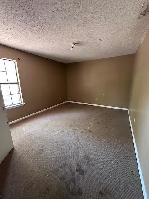 592 E Robinson Ave, Crestview, FL 32539 - carpeted spare room featuring a textured ceiling and baseboards