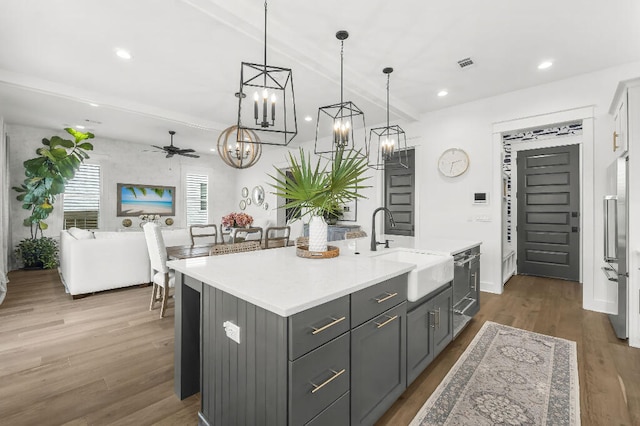 331 Ridgewalk Cir, Santa Rosa Beach, FL 32459 - kitchen featuring wood finished floors, a sink, ceiling fan with notable chandelier, gray cabinets, and light countertops