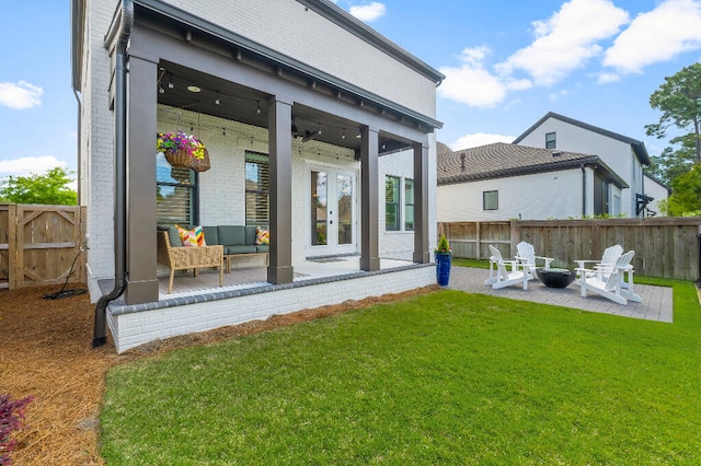 331 Ridgewalk Cir, Santa Rosa Beach, FL 32459 - rear view of property featuring a lawn, a patio, an outdoor fire pit, and french doors