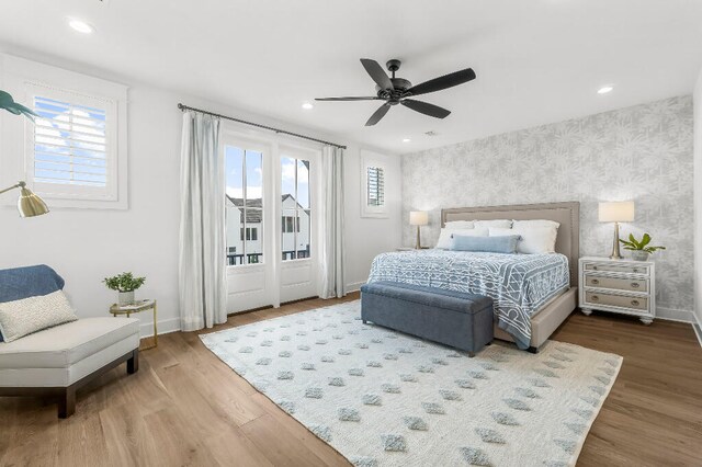 331 Ridgewalk Cir, Santa Rosa Beach, FL 32459 - bedroom featuring wallpapered walls, wood finished floors, baseboards, and multiple windows