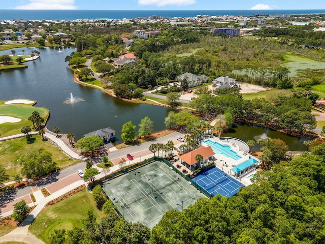 drone / aerial view with a water view and view of golf course