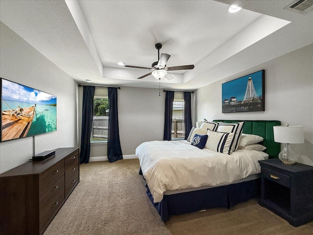 2055 Bright Water Dr, Gulf Breeze, FL 32563 - bedroom with a tray ceiling, carpet floors, baseboards, multiple windows, and recessed lighting