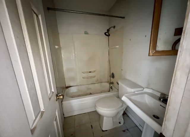bathroom with a sink, toilet, tile patterned flooring, and shower / washtub combination