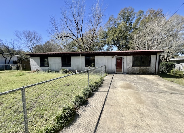 ranch-style home featuring driveway, a front yard, and fence