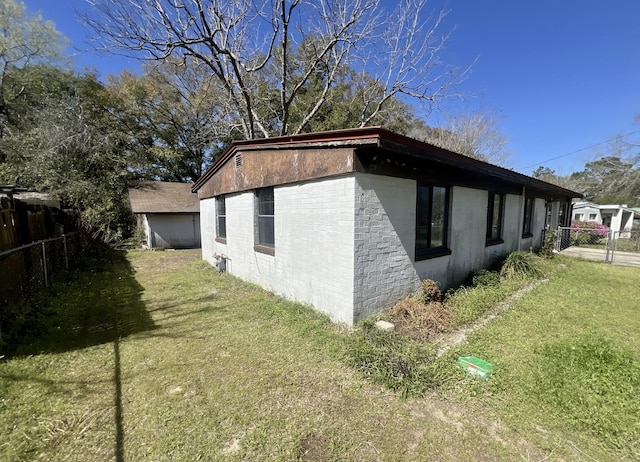 view of property exterior with a yard and fence