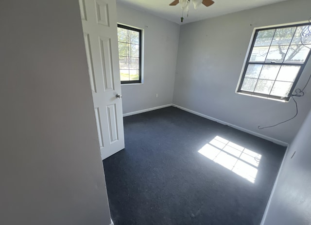 spare room featuring ceiling fan and baseboards
