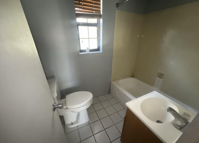 bathroom featuring toilet, tile patterned floors, and vanity