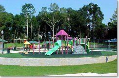 community jungle gym with a yard
