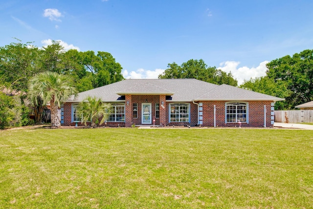 6612 Fairmont St, Navarre, FL 32566 - single story home featuring roof with shingles, brick siding, fence, and a front lawn