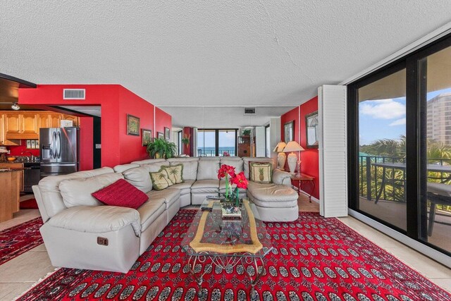 11619 Front Beach Rd Unit 201, Panama City Beach, FL 32407 - living room with visible vents, light tile patterned flooring, and a textured ceiling