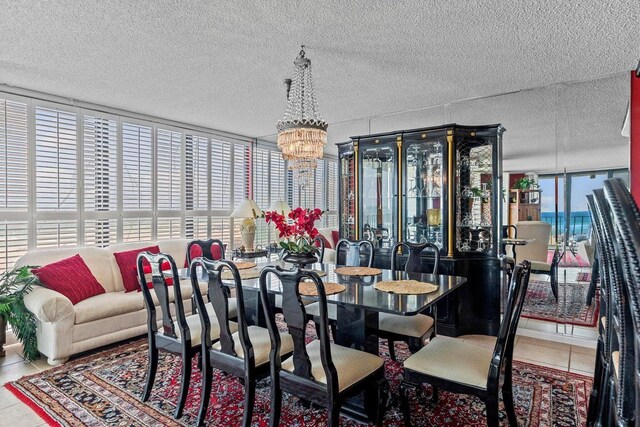 11619 Front Beach Rd Unit 201, Panama City Beach, FL 32407 - tiled dining area with a chandelier and a textured ceiling