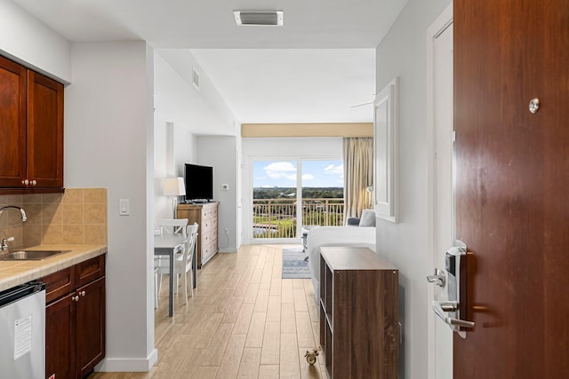 5000 S Sandestin Blvd Unit 6806, Sandestin, FL 32550 - kitchen with dishwashing machine, tasteful backsplash, visible vents, a sink, and light wood finished floors